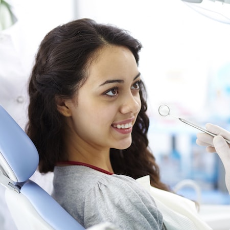 Smiling young patient who is undergoing an exam at Dental Group of Westchester