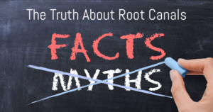 Chalkboard with hand crossing out myths about root canals