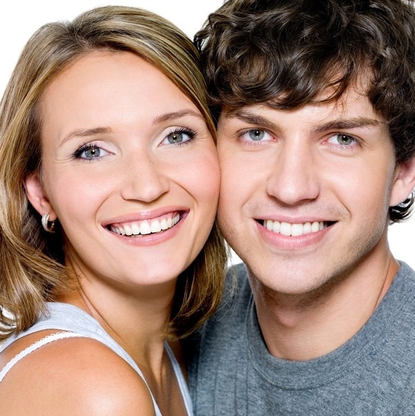 Man and woman with beautiful smiles because of Snap-On Smiles.