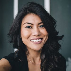Smiling woman with bright, white teeth showcasing the results of professional teeth whitening, relevant to cosmetic dentistry services in White Plains, NY.