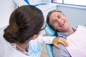 Dental professional comforting a patient in a dental office, emphasizing care and support during treatment.