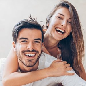 couple smiling with beautiful smiles